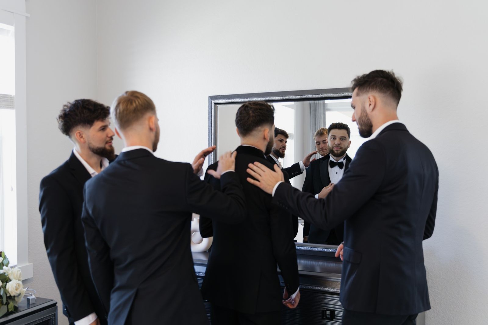 Groomsmen preparing suits before a wedding